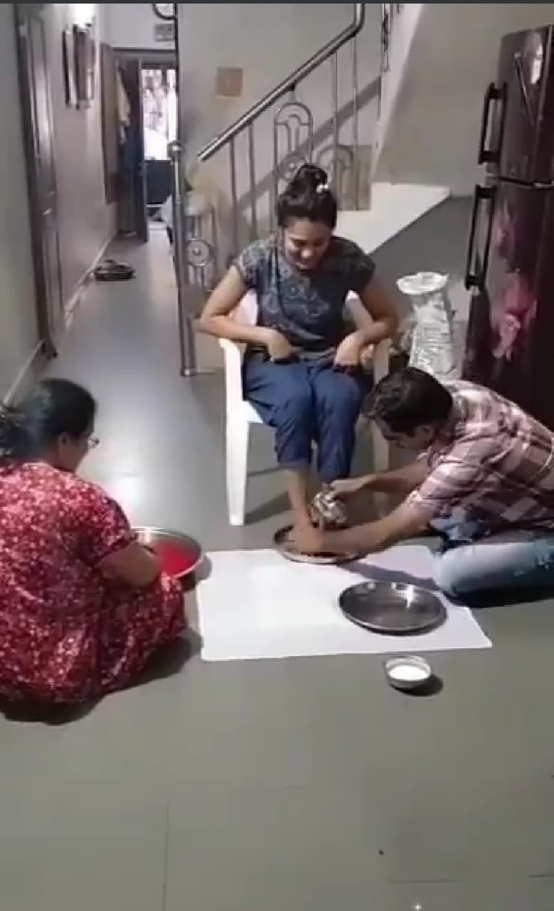 Father washes his doughter leg with milk as a traditional prewedding rituals