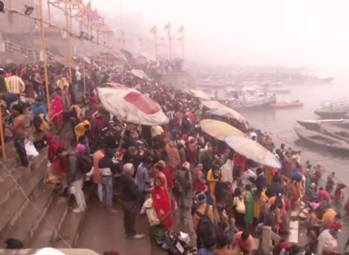 Crowds of devotees bathe in the river Ganga on the occasion of Makar Sankranti
