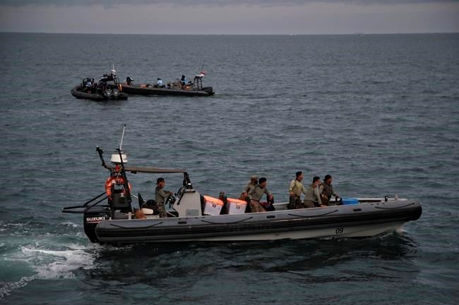 Indonesian rescuers remove body parts, clothing and metal debris from Java Sea