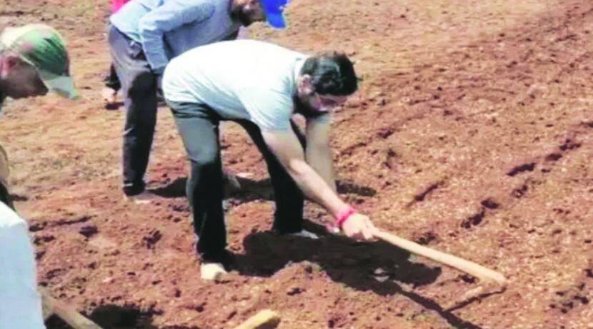 Farmer's son! A minister putting aside all his dignity while doing farm work